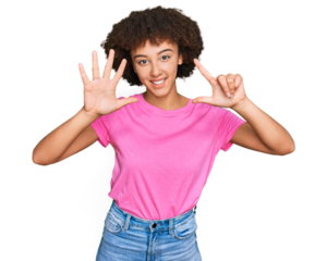 Young hispanic girl wearing casual clothes showing and pointing up with fingers number seven while smiling confident and happy.