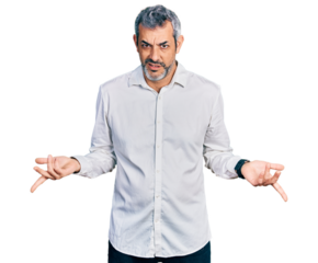 Middle age hispanic with grey hair wearing casual white shirt clueless and confused with open arms, no idea concept.