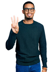 Young african american man wearing casual clothes and glasses showing and pointing up with fingers...