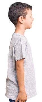 Cute blond kid wearing casual clothes looking to side, relax profile pose with natural face with confident smile.