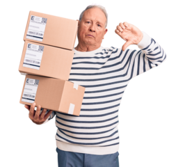 Senior handsome grey-haired man holding delivery boxes with angry face, negative sign showing dislike with thumbs down, rejection concept