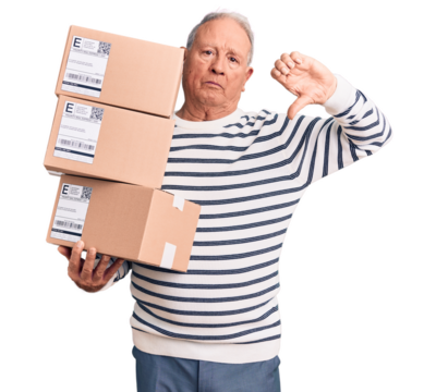 Senior handsome grey-haired man holding delivery boxes with angry face, negative sign showing dislike with thumbs down, rejection concept