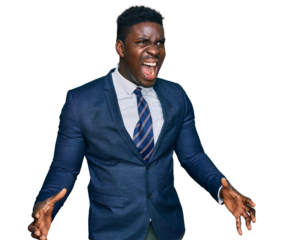 Handsome business black man wearing business suit and tie crazy and mad shouting and yelling with aggressive expression and arms raised. frustration concept.