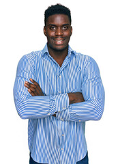 Handsome business black man wearing casual striped t shirt happy face smiling with crossed arms...