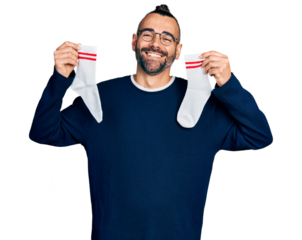 Hispanic man with ponytail holding socks smiling and laughing hard out loud because funny crazy joke.