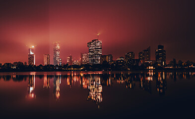 Vienna skyline reflecting on old Danube at night  - Powered by Adobe