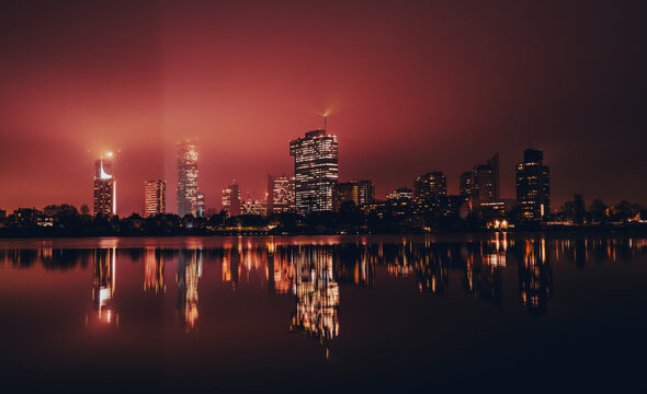 Vienna Skyline Reflecting On Old Danube At Night 