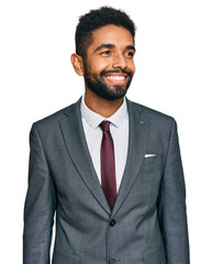 Young african american man wearing business clothes looking away to side with smile on face, natural expression. laughing confident. - obrazy, fototapety, plakaty