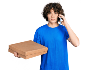 Caucasian teenager holding delivery package and talking by the smartphone relaxed with serious expression on face. simple and natural looking at the camera.