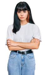 Young hispanic girl wearing casual clothes skeptic and nervous, disapproving expression on face...