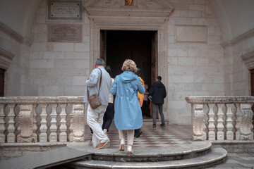 Believers entering the Cathedral of Saint Tryphon in Kotor Old Town, Montenegro