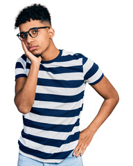 Young african american man wearing casual clothes and glasses thinking looking tired and bored with depression problems with crossed arms.