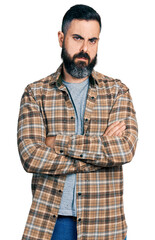 Fototapeta premium Hispanic man with beard with arms crossed gesture clueless and confused expression. doubt concept.