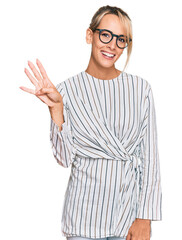 Beautiful blonde woman wearing business shirt and glasses showing and pointing up with fingers number four while smiling confident and happy.