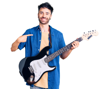 Young hispanic man playing electric guitar pointing finger to one self smiling happy and proud