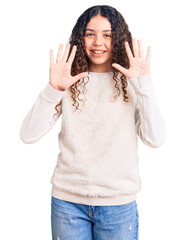 Beautiful kid girl with curly hair wearing casual clothes showing and pointing up with fingers number ten while smiling confident and happy.