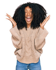 Young african american girl wearing casual clothes celebrating mad and crazy for success with arms...