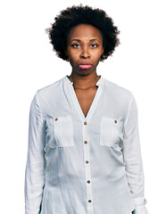 African american woman with afro hair wearing casual white t shirt depressed and worry for distress, crying angry and afraid. sad expression.