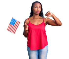 Young african american woman holding united states flag with angry face, negative sign showing dislike with thumbs down, rejection concept