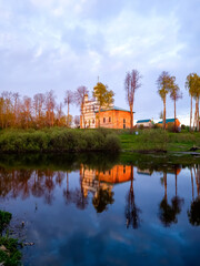 The old Orthodox church on the shore of the lake at sunset