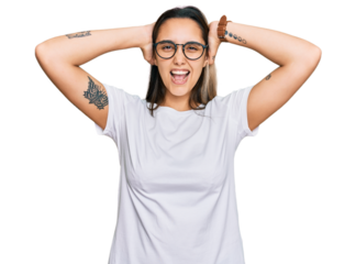 Young hispanic woman wearing casual white t shirt crazy and scared with hands on head, afraid and surprised of shock with open mouth