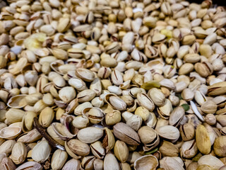 a lot of nuts: almonds, peanuts, pistachios are in a box in the store.