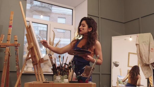 Yong Woman Painter Artist in Studio with Easel