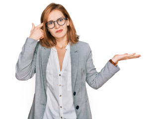 Young caucasian woman wearing business style and glasses confused and annoyed with open palm showing copy space and pointing finger to forehead. think about it.