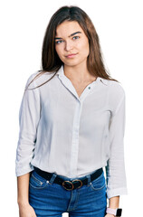 Young caucasian girl wearing casual white shirt relaxed with serious expression on face. simple and natural looking at the camera.
