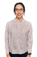 Young hispanic girl wearing casual clothes and glasses with a happy and cool smile on face. lucky person.