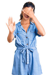 Young beautiful woman wearing casual clothes covering eyes with hands and doing stop gesture with sad and fear expression. embarrassed and negative concept.