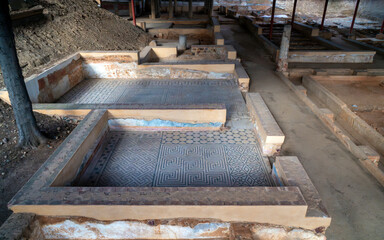 Archaeological remains of the floors of different Roman rooms with the floor decorated with mosaics with blue geometric figures that create a fractal structure in the Mitreo house in Mérida, Spain.