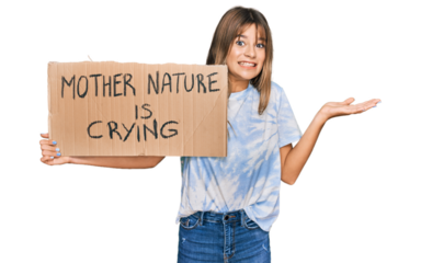 Teenager caucasian girl holding mother nature is crying protest cardboard banner celebrating victory with happy smile and winner expression with raised hands