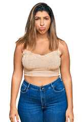 Fototapeta premium Beautiful brunette woman wearing casual clothes depressed and worry for distress, crying angry and afraid. sad expression.