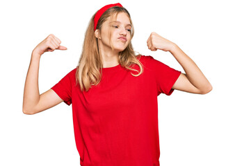 Obraz na płótnie Canvas Beautiful young caucasian girl wearing casual red t shirt showing arms muscles smiling proud. fitness concept.