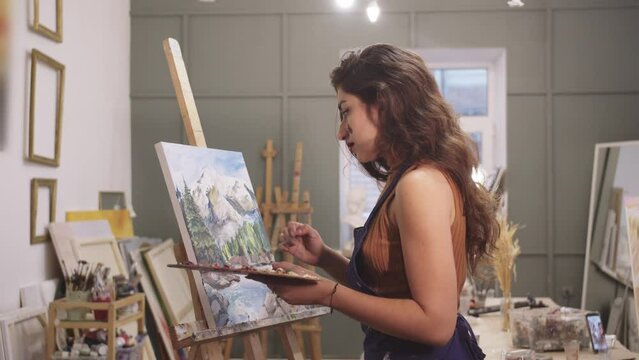 Yong Woman Painter Creating Art in Studio