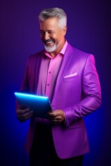 A Sophisticated Man in a Vibrant Purple Suit Holding a High-Tech Tablet