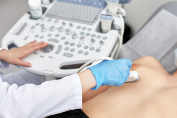 Young woman getting breast examination by her gynecologist ultrasound scanning sonography...