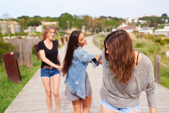 Friends: Girls walking on path.