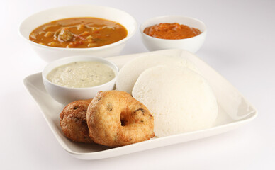 Idly, medu wada, coconut chutney, onion and tomato red chutney, vegetable sambhar- a south Indian traditional tiffin or lunch 