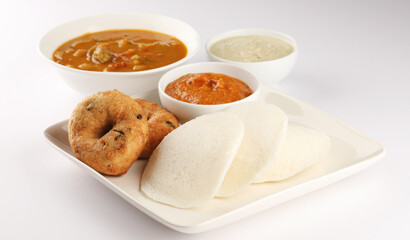 Idly, medu wada, coconut chutney, onion and tomato red chutney, vegetable sambhar- a south Indian traditional tiffin or lunch 
