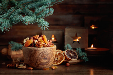Dried fruits and assorted nuts on an old wooden table.