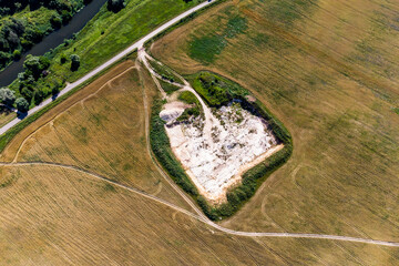 Aerial view of a small limestone quarry in the middle of a field