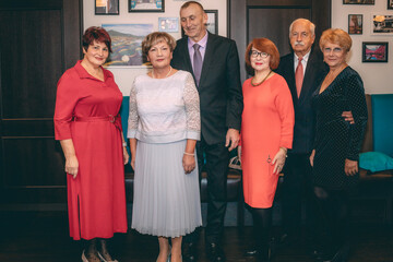 Group of Happy Adults Celebrating Together. A group of happy adults smiling and celebrating together at an event.