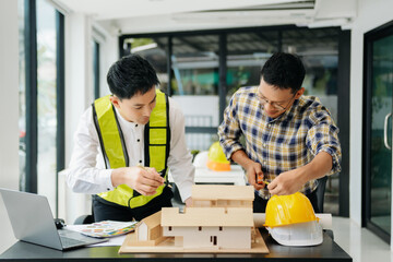 Engineer Teamwork Meeting, Drawing working on blueprint meeting for project working with partner on model building at office. Asian industry professional team.