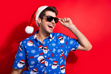 Photo portrait of nice young male touch sunglass cool have fun dressed santa claus print x-mas...