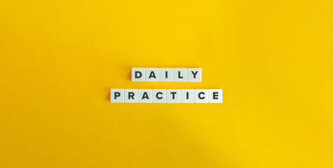 Daily Practice Text on Block Letter Tiles on Yellow Background. Minimalist Aesthetics. Strong Word Ethic, Commitment, and Self-discipline Concept. - obrazy, fototapety, plakaty