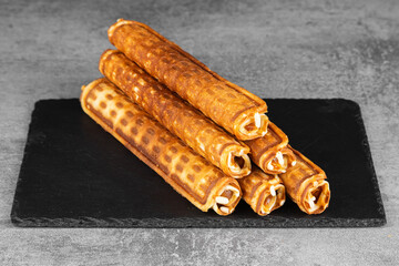 Homemade waffles with caramel. .Wafer rolls with condensed milk. Thin and Crispy Waffle