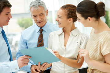Fototapeta premium Business people, paperwork and collaboration on documents, cooperation and strategy in office. Colleagues, planning and brainstorming or analysis, discussion and meeting for report, teamwork on sale