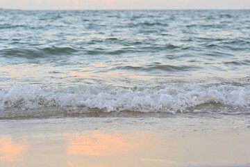 A beautiful wave of soft-breaking on the beach during daytime. Close up no people